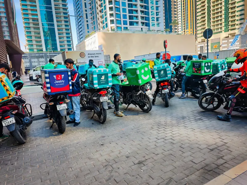group couriers scooters delivering food dubai apartment background urban street city life food delivery dubai uae group 421097984